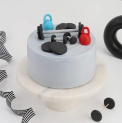 Gym-themed cake featuring weights, dumbbells, and fitness-inspired edible decorations, ideal for gym lovers and workout celebrations.