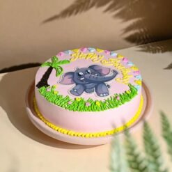 Adorable Pink Baby Elephant Cake with fondant elephant topper, pastel decorations, and creamy layers, ideal for baby showers and birthdays.
