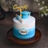 Proud Moment Graduation Cake with a graduation cap, diploma decorations, and elegant frosting, ideal for celebrating academic milestones.