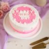 Rosy Elegance Women's Day Cake – a stunning pink-themed cake with delicate floral decor, symbolizing beauty, grace, and empowerment.