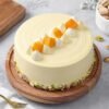 Mango Slices Luxe Cake — premium layered cake topped with fresh mango slices and smooth cream, styled for a luxurious dessert experience.