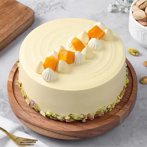 Mango Slices Luxe Cake — premium layered cake topped with fresh mango slices and smooth cream, styled for a luxurious dessert experience.
