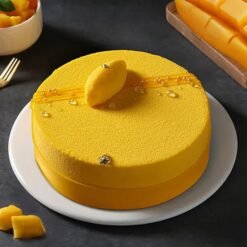 Mango Temptation Cream Cake — layered cream cake topped with juicy mango slices and a smooth mango glaze.