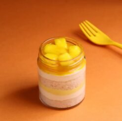 Dreamy Mango Jar Cake with mango mousse and sponge layers in a transparent dessert jar.