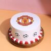 Football Team Manchester United Cake featuring red and black design, club logo, and football decorations.