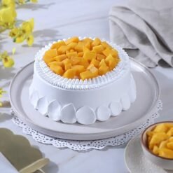 Golden Delight Mango Cake topped with fresh mango slices and golden accents.