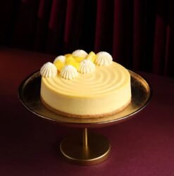 Golden Dream Mango Cheesecake with mango glaze and fresh mango slices on top.