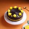 Mango Choco Magic Cake with layers of chocolate sponge and mango cream, garnished with mango chunks and chocolate drizzle.