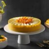 Mango Love Bite Cheesecake topped with mango glaze and heart-shaped decorations.