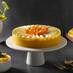 Mango Love Bite Cheesecake topped with mango glaze and heart-shaped decorations.