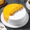 Mango Mellow Bliss Cake topped with mango swirls and a smooth glaze.