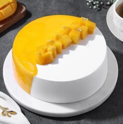 Mango Mellow Bliss Cake topped with mango swirls and a smooth glaze.