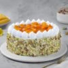 Mango Pistachio Cream Cake topped with mango slices and crushed pistachios.