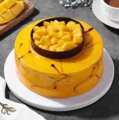 Sunshine Mango Treat Cake topped with fresh mango cubes and a golden glaze.